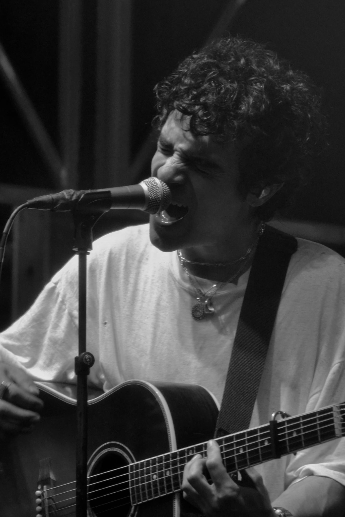 a singer with an acoustic guitar, in black and white